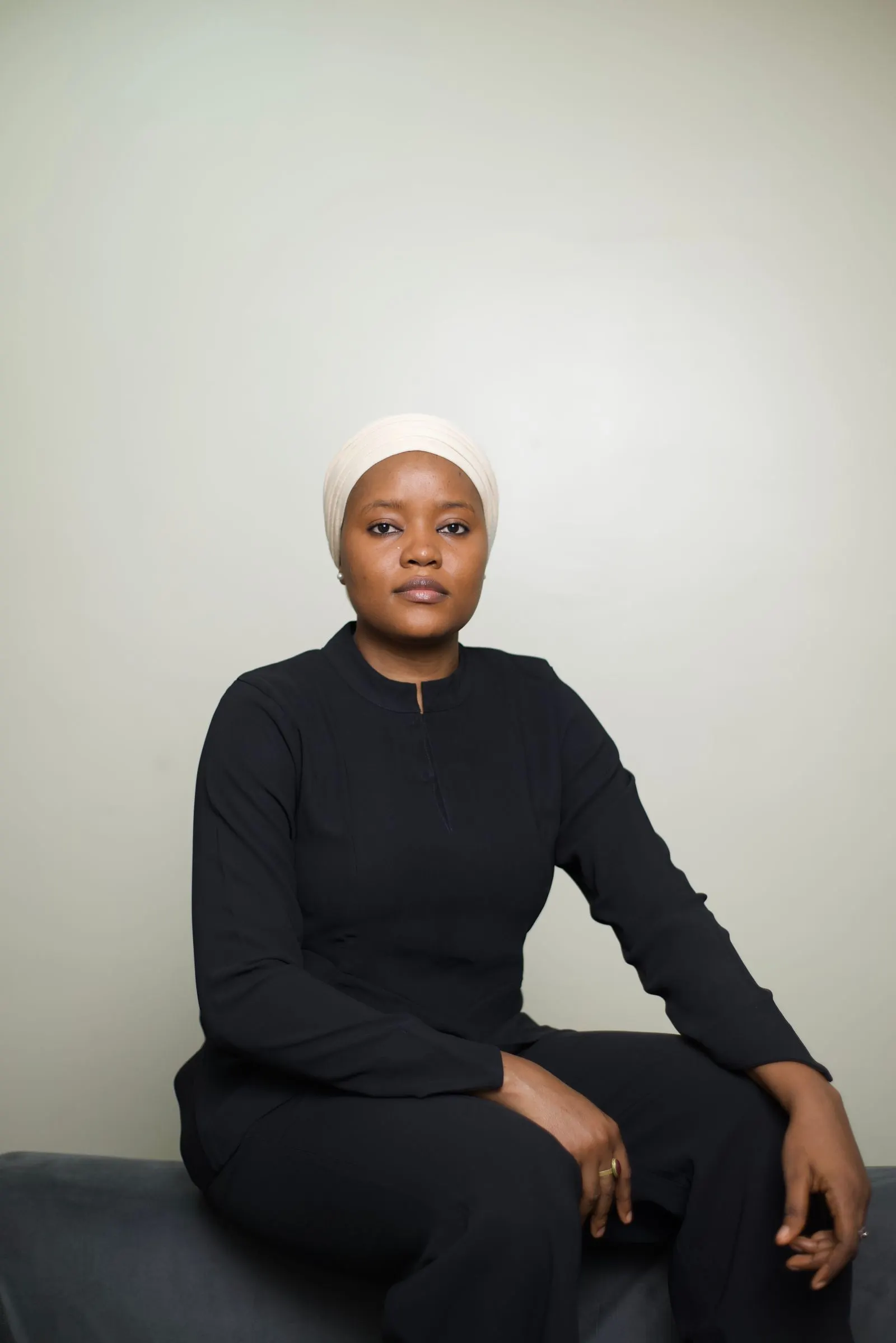A businesswoman in Abuja in a headscarf, photographed in a studio