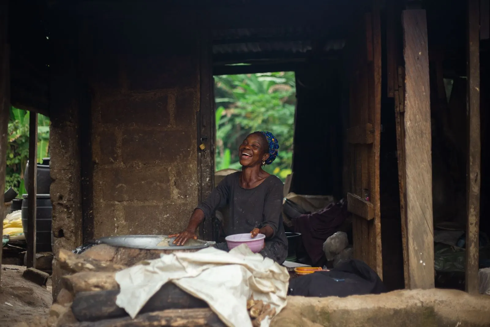A woman in Ibadan prepares food in her open kitchen