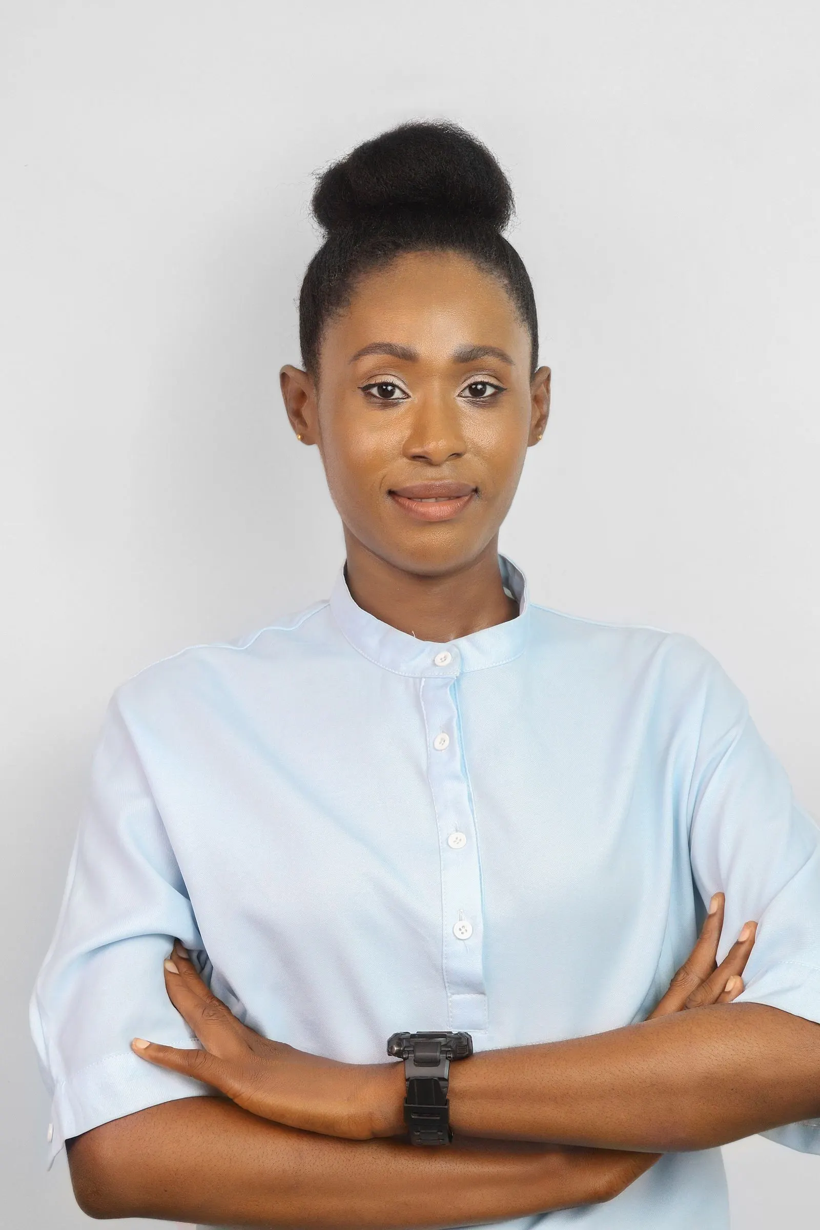 A businesswoman in Lagos stands with her arms crossed